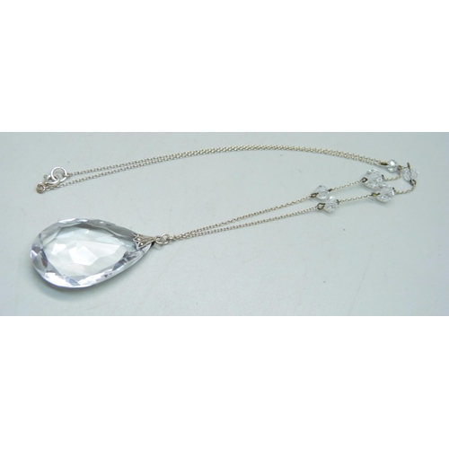 1064 - A circa 1930 rock crystal faceted teardrop pendant with fancy spacers on silver chain, 16.9g, 56cm a... 