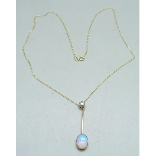 1067 - An Edwardian Australian crystal opal pendant set in 15ct yellow gold with split pearl bail on a fine... 