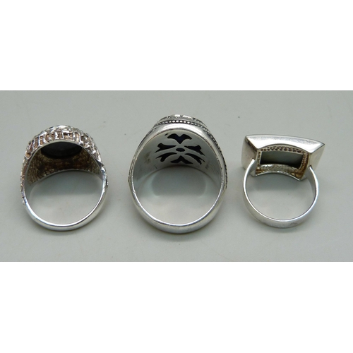 1081 - Three silver sings - one set with carved hematite, R, one set with abalone, M, and the other with a ... 