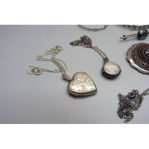 1083 - A large silver locket, 5x3.8 cm, three silver bangles, a Siam niello silver fan brooch, three silver... 