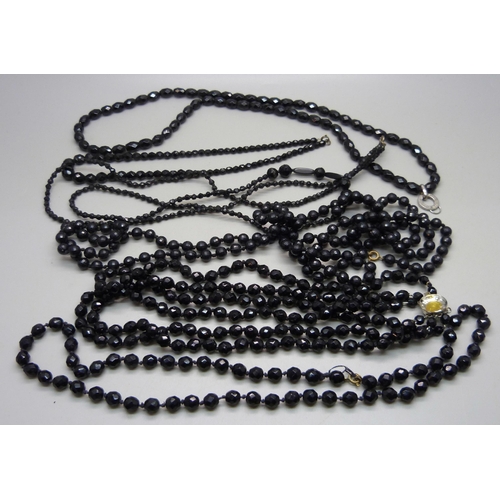 1084 - Five French jet necklets and a plastic bead necklace