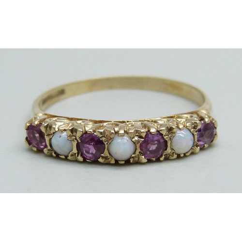 1094 - A 9ct gold ring set with three opals and four rubies, 2.5g, Q