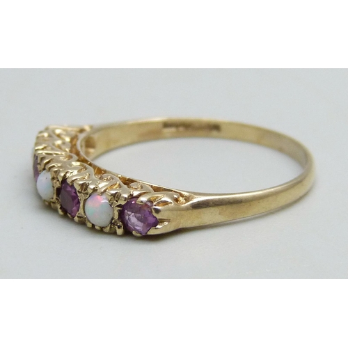 1094 - A 9ct gold ring set with three opals and four rubies, 2.5g, Q