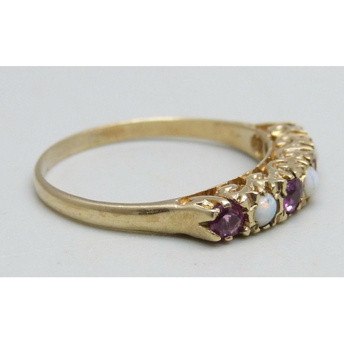 1094 - A 9ct gold ring set with three opals and four rubies, 2.5g, Q