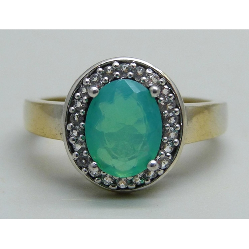 1097 - A silver gilt cluster ring set with a central green stone and white stone halo, Q