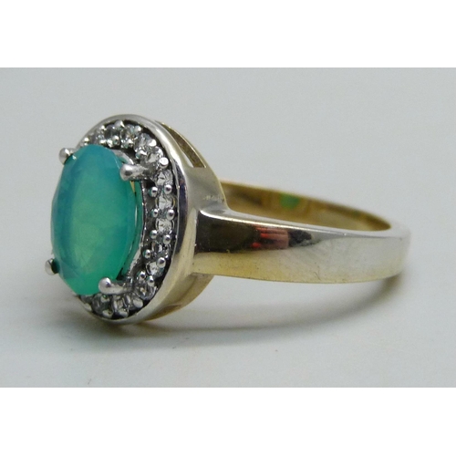 1097 - A silver gilt cluster ring set with a central green stone and white stone halo, Q