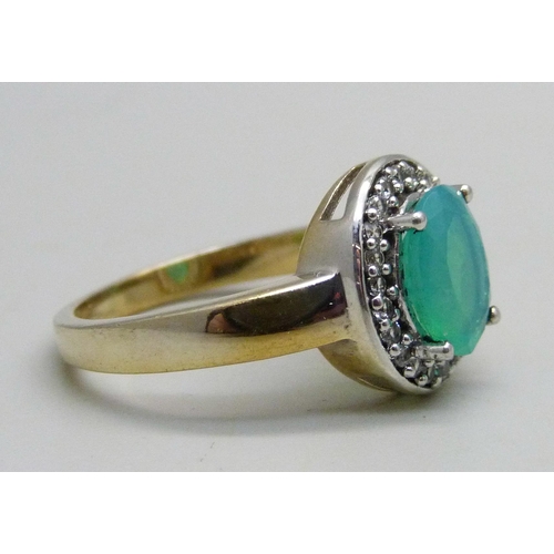 1097 - A silver gilt cluster ring set with a central green stone and white stone halo, Q