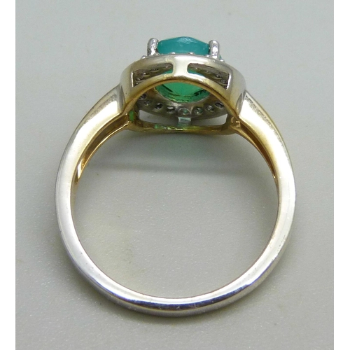 1097 - A silver gilt cluster ring set with a central green stone and white stone halo, Q