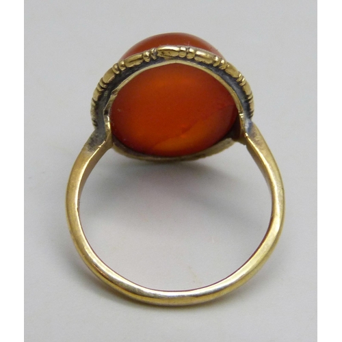 1099 - A yellow metal ring set with a cabochon chalcedony stone, 3.8g, N