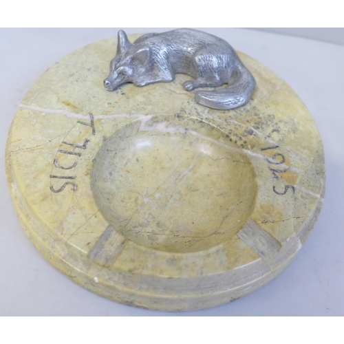 639 - A stone ash tray marked Sicily 1945, with a fox