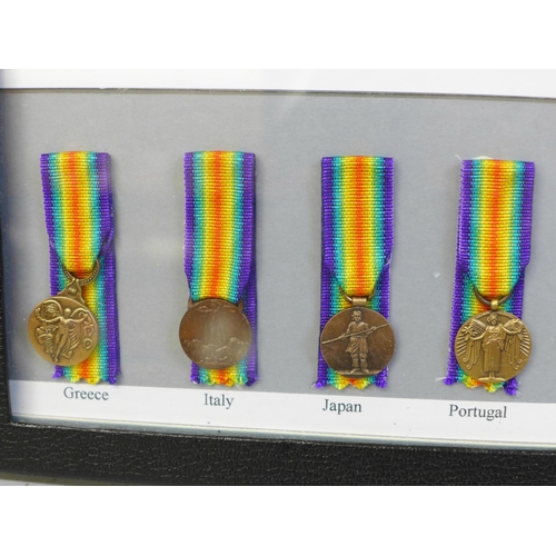 649 - A framed collection of sixteen Allied Victory Medals of WWI miniature medals