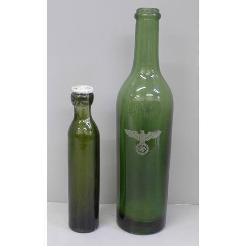 677 - A WWI Clark 'D' Gas bottle and one other heavy green glass bottle with etched Reichsadler and Swasti... 