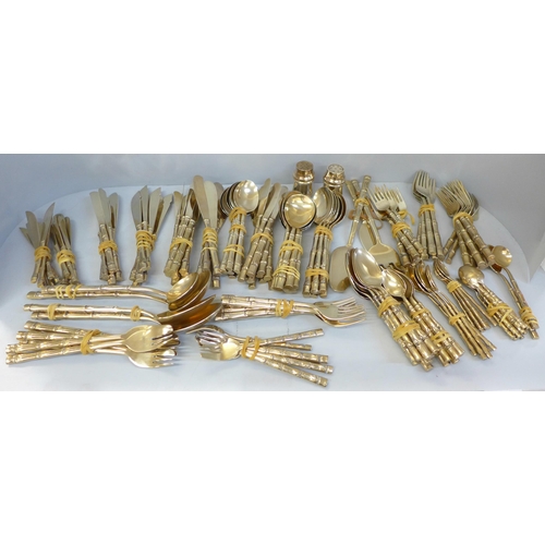 678 - A Thai brass cutlery set with bamboo form handles