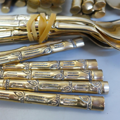 678 - A Thai brass cutlery set with bamboo form handles