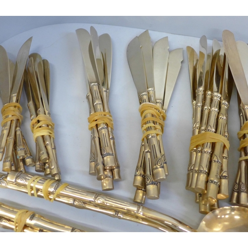 678 - A Thai brass cutlery set with bamboo form handles