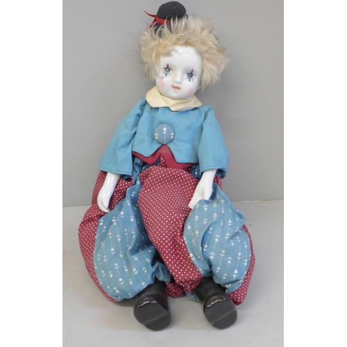 697 - A vintage clown doll with porcelain head and arms