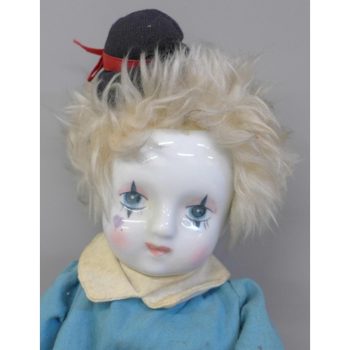 697 - A vintage clown doll with porcelain head and arms