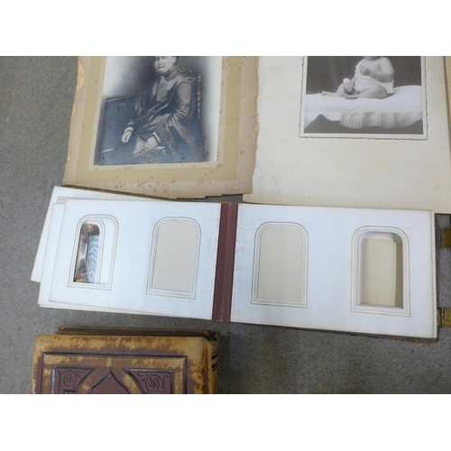 749 - Two Victorian photograph albums containing carte de visites and cabinet cards, both incomplete and o... 