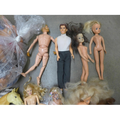 825 - A box of vintage Barbie dolls, vintage Trolls, Action Man and a model horse