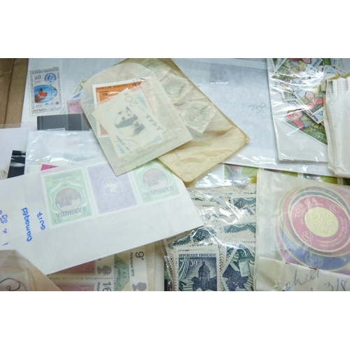 830 - Stamps; a box of stamps on stock cards and in packets