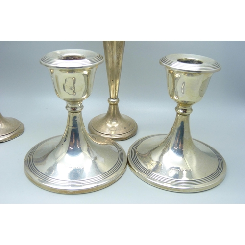 844 - A pair of silver candlesticks, a pair of silver vases, four silver spoons, a/f, an 830 shot and a si... 