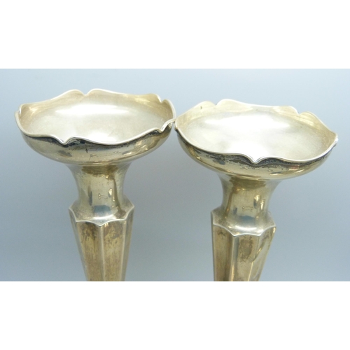 844 - A pair of silver candlesticks, a pair of silver vases, four silver spoons, a/f, an 830 shot and a si... 