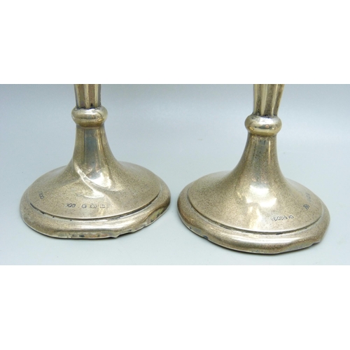 844 - A pair of silver candlesticks, a pair of silver vases, four silver spoons, a/f, an 830 shot and a si... 