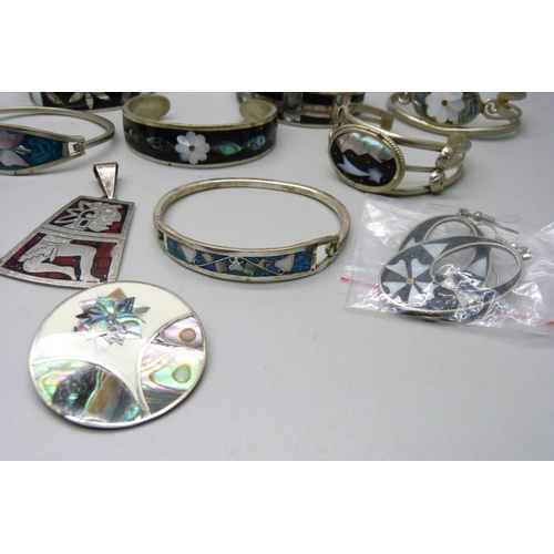 865 - A collection of silver, alpaca and other jewellery, seven bangles, seven pairs of earrings, two broo... 