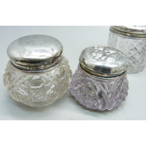 876 - Two silver top jars, Birmingham 1902 and 1907 and two others decorated with Reynolds angels