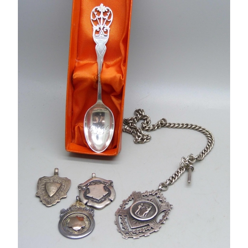 891 - Three silver fob medals including one cricket and one boxing, a silver watch chain and a golf spoon,... 