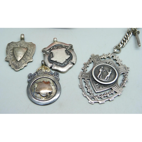 891 - Three silver fob medals including one cricket and one boxing, a silver watch chain and a golf spoon,... 