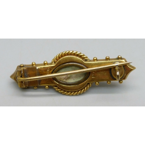 935 - A 9ct gold bar brooch, set with eight blue stones and a central pearl, 3.8g, 4cm