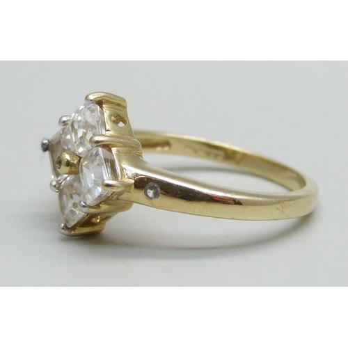 937 - A 9ct gold ring set with four square cut spinel, 2.9g, N