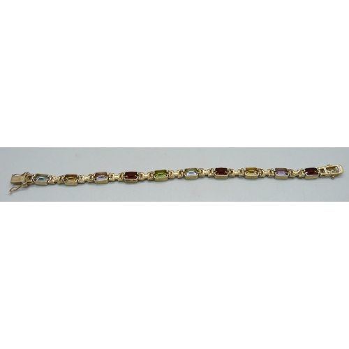 939 - A silver gilt bracelet set with amethyst, citrine, garnet and topaz, 19cm