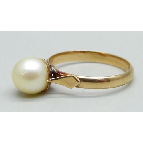 945 - A yellow metal ring set with a pearl, 2.82g, P, stamps to outer shank, pearl re-glued