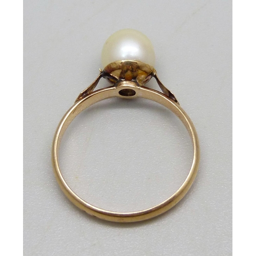 945 - A yellow metal ring set with a pearl, 2.82g, P, stamps to outer shank, pearl re-glued