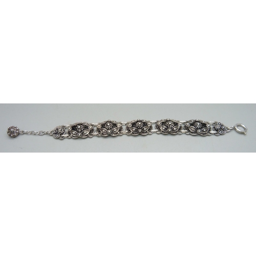 957 - A silver filigree bracelet, clasp marked Sterling, 33g, 21.5cm