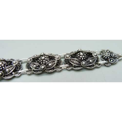 957 - A silver filigree bracelet, clasp marked Sterling, 33g, 21.5cm