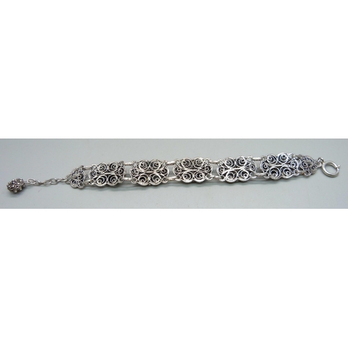 957 - A silver filigree bracelet, clasp marked Sterling, 33g, 21.5cm