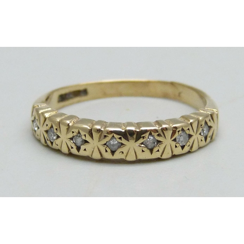 964 - A 9ct gold ring set with seven diamonds, 1.6g, L