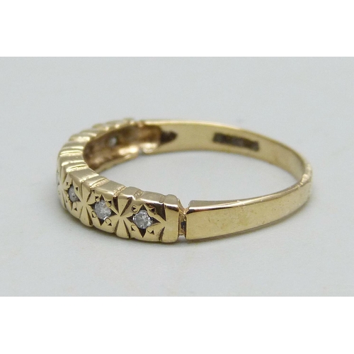 964 - A 9ct gold ring set with seven diamonds, 1.6g, L