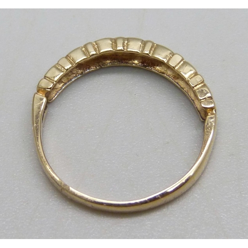 964 - A 9ct gold ring set with seven diamonds, 1.6g, L