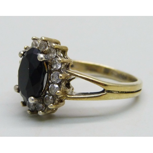 966 - A silver gilt cluster ring set with a a black stone and cubic zirconia halo, M