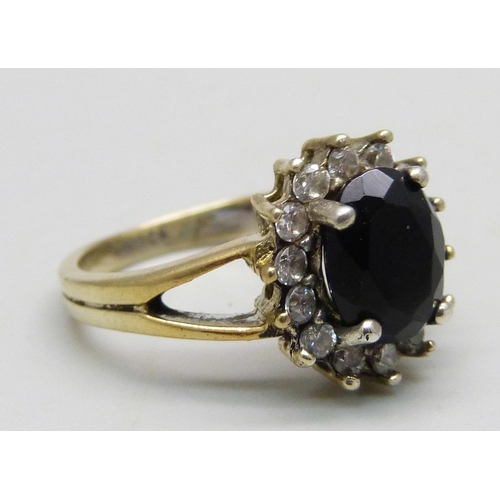 966 - A silver gilt cluster ring set with a a black stone and cubic zirconia halo, M