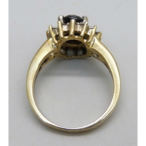 966 - A silver gilt cluster ring set with a a black stone and cubic zirconia halo, M