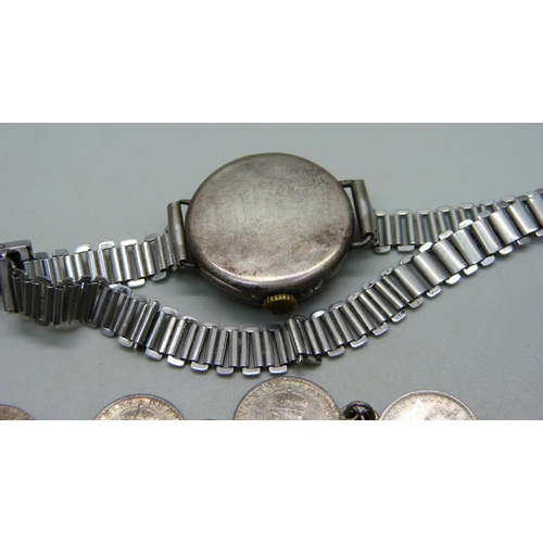 980 - A silver charm bracelet with silver and white metal charms, a silver cased wristwatch, a bracelet ma... 