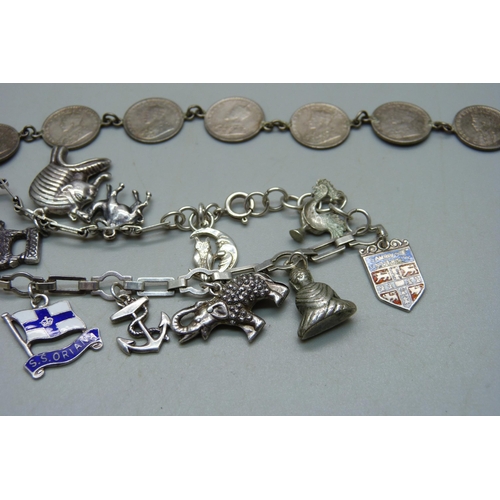 980 - A silver charm bracelet with silver and white metal charms, a silver cased wristwatch, a bracelet ma... 