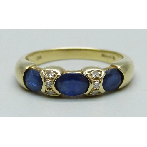 982 - A 14ct gold ring set with three sapphires and six diamonds, 4.4g, R