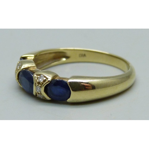 982 - A 14ct gold ring set with three sapphires and six diamonds, 4.4g, R