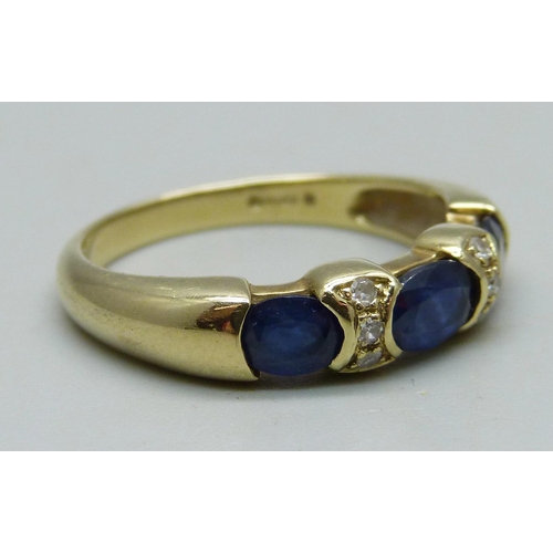 982 - A 14ct gold ring set with three sapphires and six diamonds, 4.4g, R